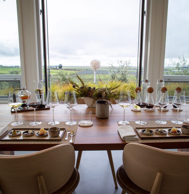 A view of Donum Estate's wine tasting with a flight of 4 glasses and paired bites.