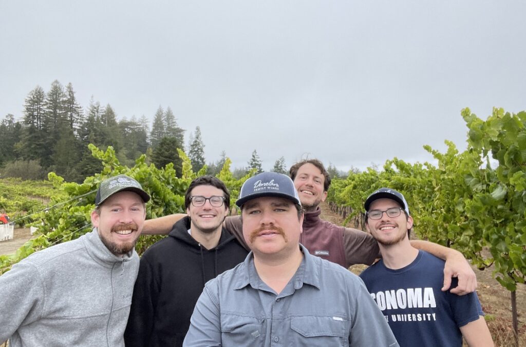 David posing with Donelan Production Associate Chris Spradling (left) and our harvest interns from the season.